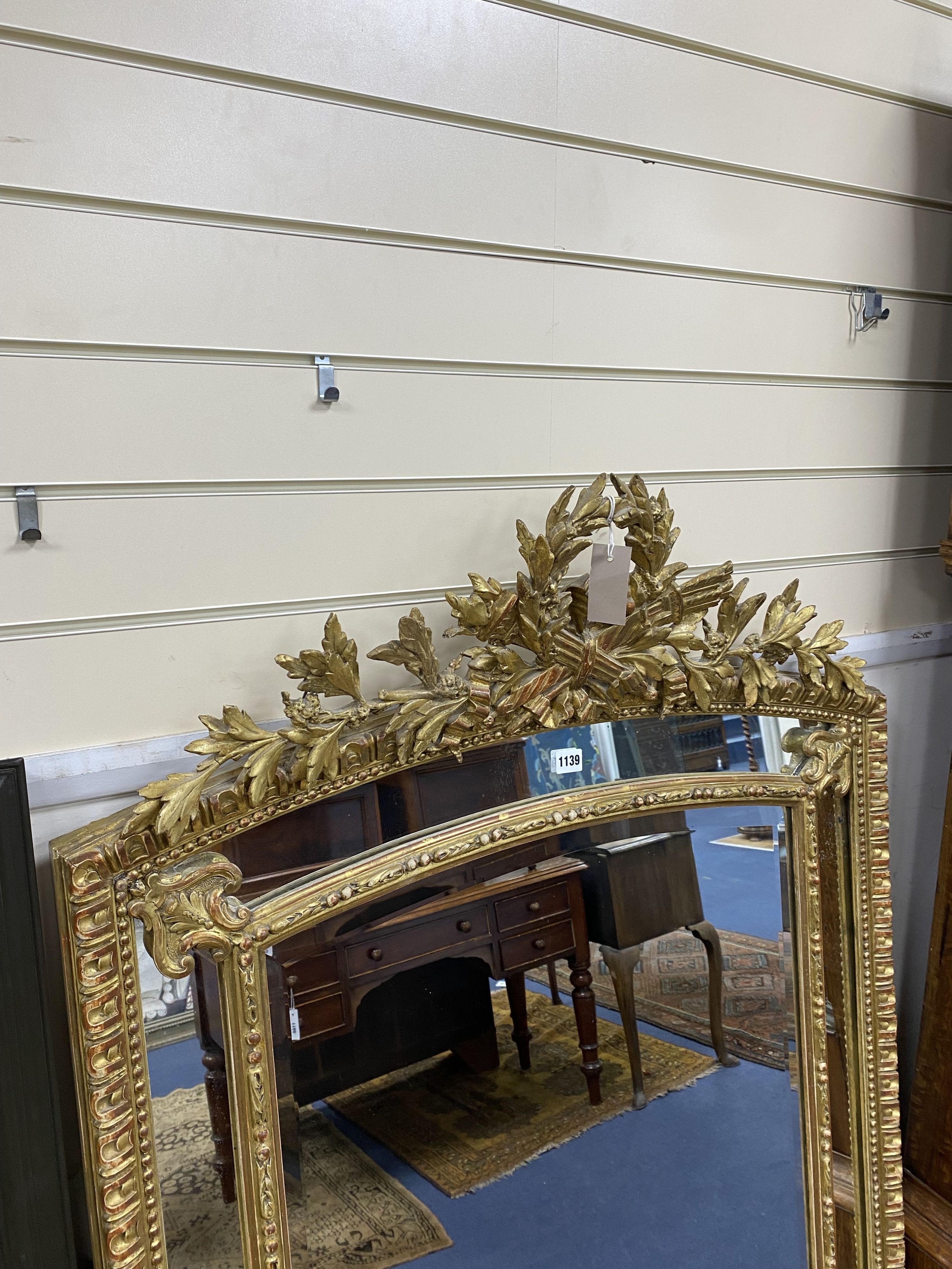 A 19th century giltwood and gesso overmantel mirror with Olympic Torch & Laurel Crown, side cushions with decorated bead detail, width 92cm, height 153cm